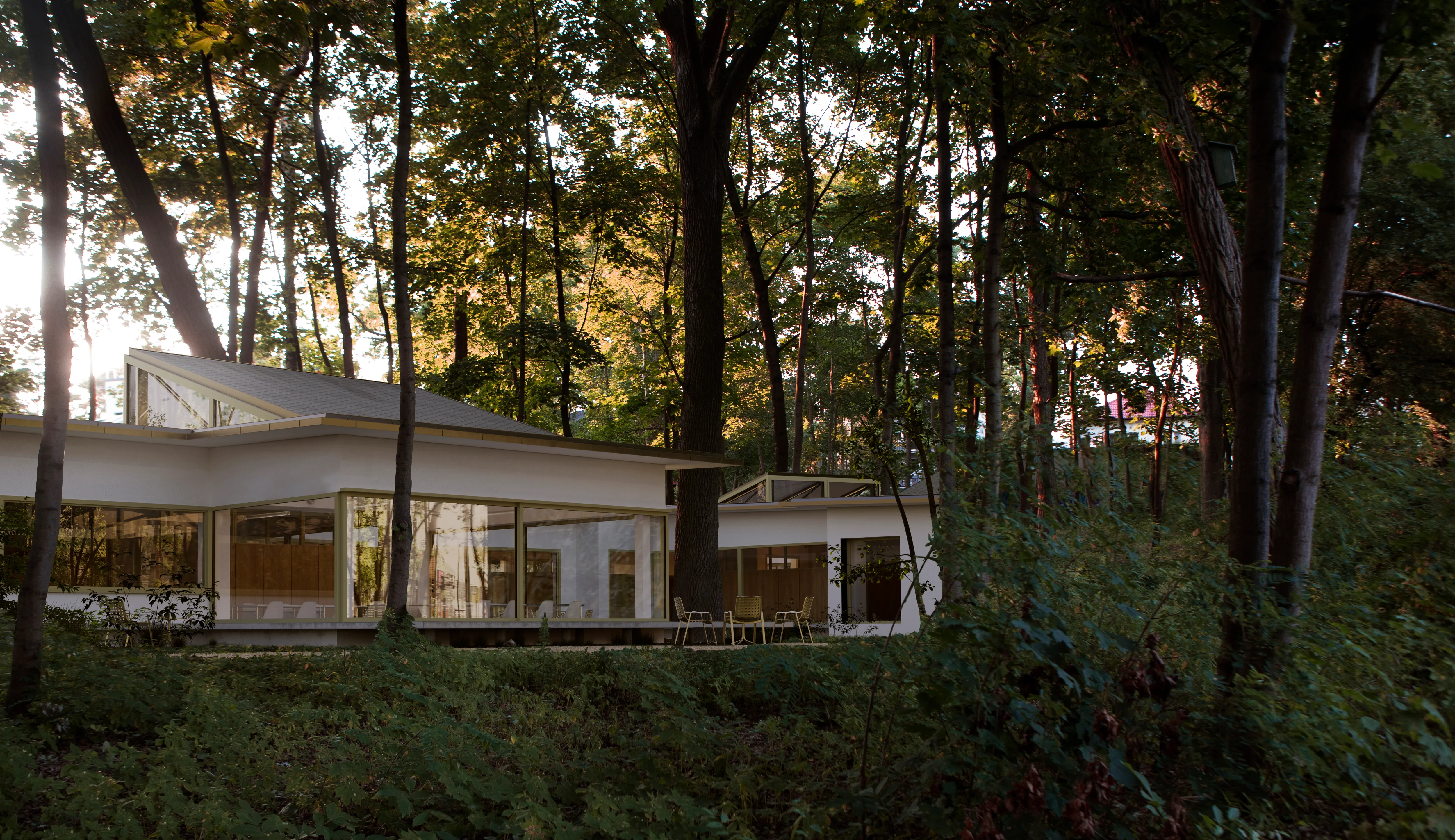 An exterior view of the facade of a day care building in Warsaw Wesoła located on a wooded lot winding around existing trees.