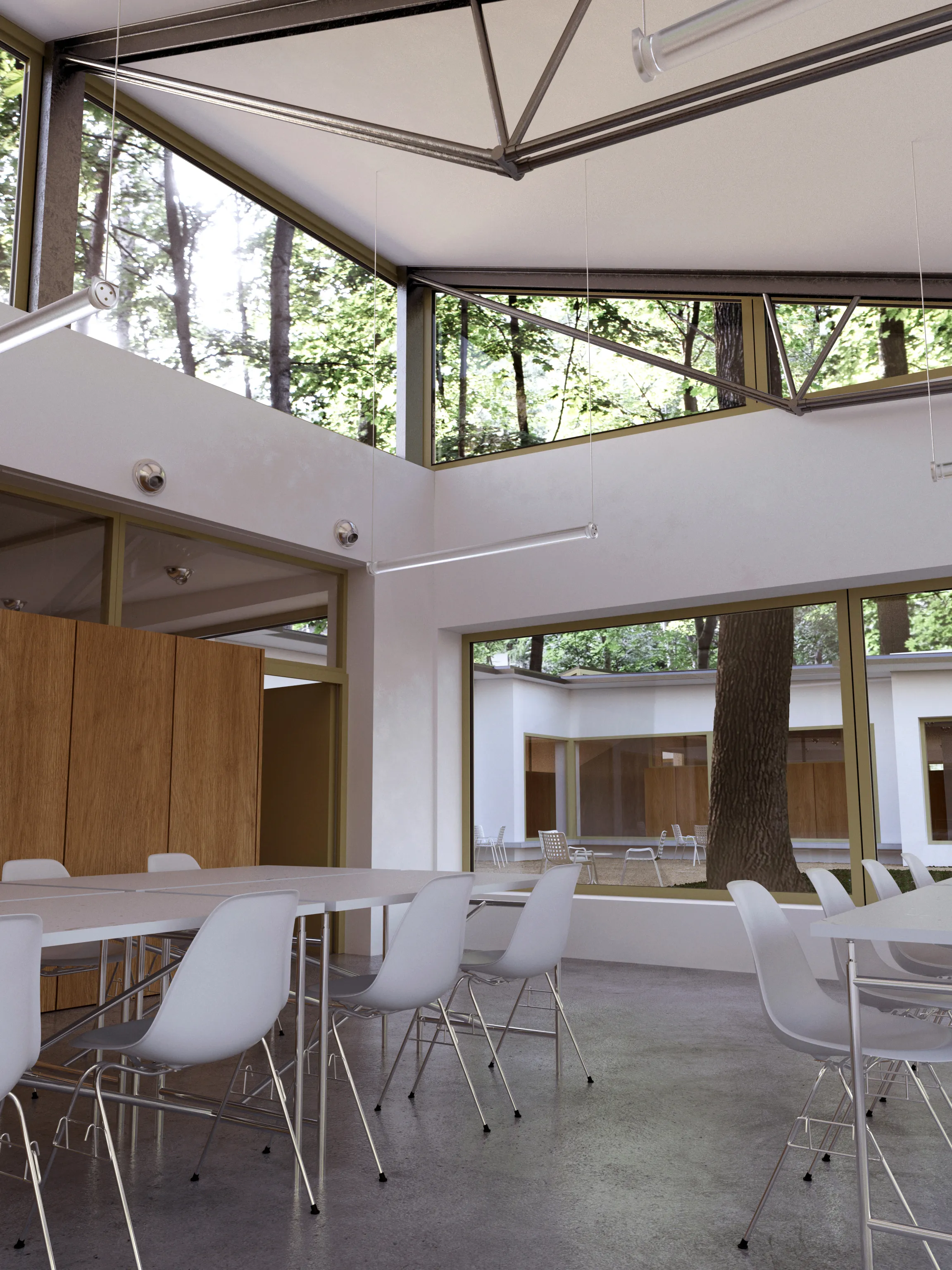 The interior of the canteen of a day care center building in Warsaw Wesoła with tables and groups of chairs in the foreground..